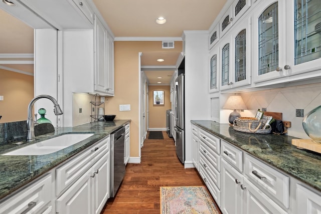 14655 Champion Forest Dr Unit 1704, Houston, TX 77069 - kitchen with white cabinetry, crown molding, dark wood finished floors, dark stone counters, and stainless steel appliances