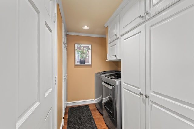 14655 Champion Forest Dr Unit 1704, Houston, TX 77069 - laundry area featuring washer and clothes dryer, cabinet space, dark wood finished floors, crown molding, and recessed lighting