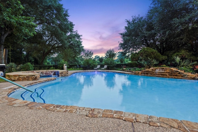 14655 Champion Forest Dr Unit 1704, Houston, TX 77069 - pool at dusk featuring a jacuzzi and an outdoor pool