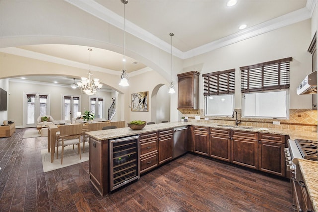 1516 Cohn St, Houston, TX 77007 - kitchen featuring wine cooler, arched walkways, stainless steel dishwasher, stove, and recessed lighting