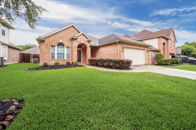 20779 Oakhurst Meadows Dr, Porter, TX 77365 - traditional-style house with brick siding, a garage, and driveway