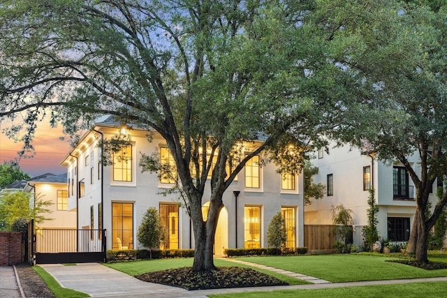 2220 Pelham Dr, Houston, TX 77019 - view of front facade with stucco siding and a gate