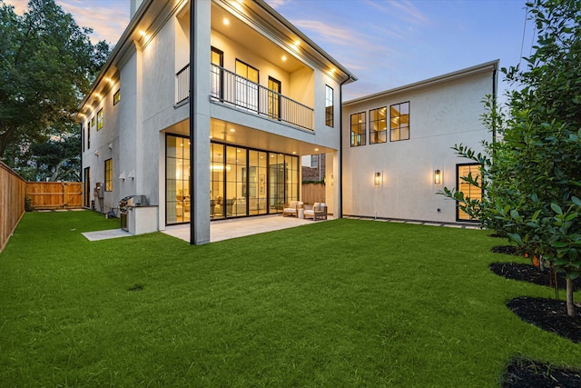 2220 Pelham Dr, Houston, TX 77019 - rear view of property featuring a balcony, stucco siding, a fenced backyard, and a patio