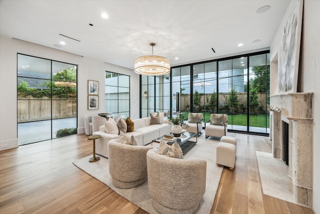 2220 Pelham Dr, Houston, TX 77019 - living area with light wood-style floors, a high end fireplace, a chandelier, and recessed lighting