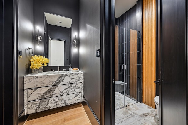 2220 Pelham Dr, Houston, TX 77019 - full bathroom featuring a shower stall, vanity, and wood finished floors