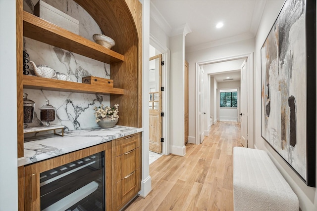 2220 Pelham Dr, Houston, TX 77019 - bar with wine cooler, light wood-style floors, ornamental molding, and backsplash