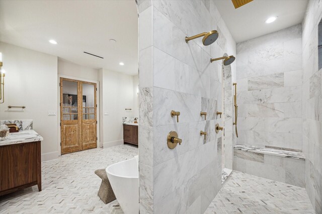 2220 Pelham Dr, Houston, TX 77019 - full bathroom featuring walk in shower, two vanities, recessed lighting, and a soaking tub
