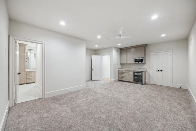2220 Pelham Dr, Houston, TX 77019 - unfurnished living room featuring wine cooler, recessed lighting, light carpet, and ceiling fan