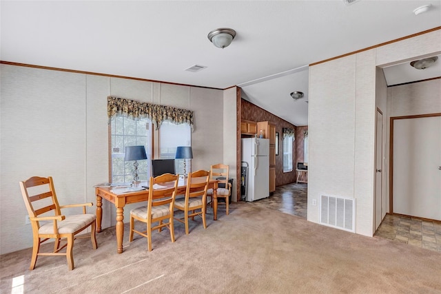 637 Troy St, Anahuac, TX 77514 - dining space with healthy amount of natural light, vaulted ceiling, light colored carpet, and ornamental molding
