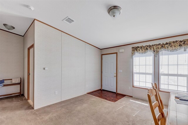 637 Troy St, Anahuac, TX 77514 - foyer entrance with light colored carpet, crown molding, and vaulted ceiling