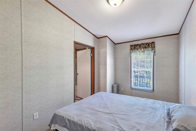 637 Troy St, Anahuac, TX 77514 - bedroom with ornamental molding, radiator, lofted ceiling, and a textured ceiling