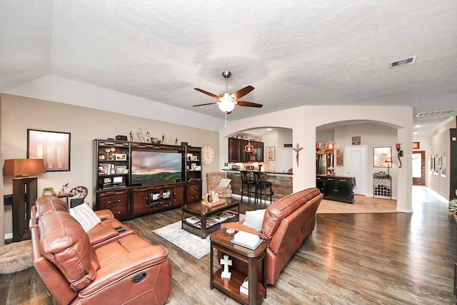 22819 Jetty Manor Ln, Spring, TX 77373 - living room with arched walkways, wood finished floors, ceiling fan, and a textured ceiling