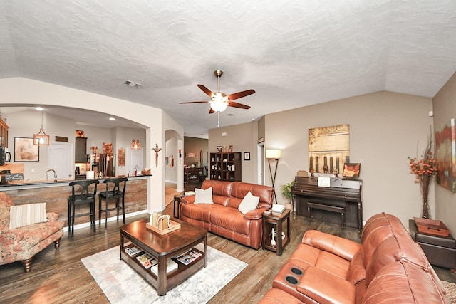 22819 Jetty Manor Ln, Spring, TX 77373 - living area featuring arched walkways, ceiling fan, vaulted ceiling, and wood finished floors