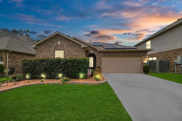 22819 Jetty Manor Ln, Spring, TX 77373 - traditional-style home featuring brick siding, roof mounted solar panels, an attached garage, and concrete driveway