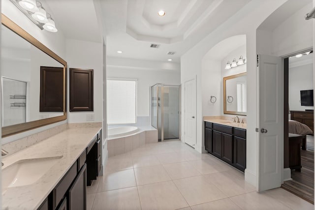 31013 Sunfall Trail Ln, Spring, TX 77386 - full bath featuring a stall shower, a garden tub, two vanities, tile patterned floors, and a tray ceiling