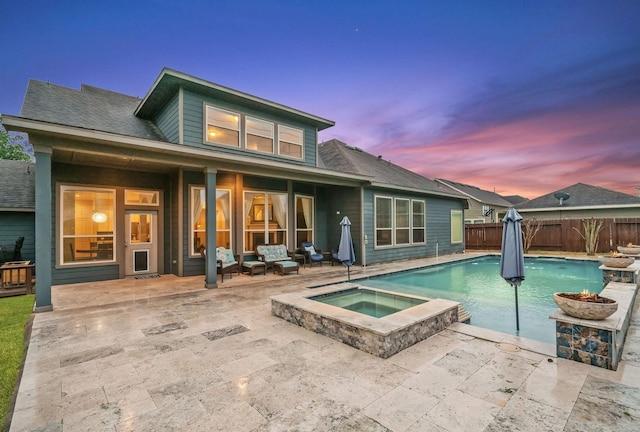 31013 Sunfall Trail Ln, Spring, TX 77386 - back of house featuring a fenced backyard, a patio, a pool with connected hot tub, and a shingled roof