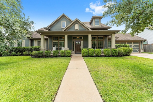31013 Sunfall Trail Ln, Spring, TX 77386 - craftsman-style house featuring a porch, a front yard, driveway, and an attached garage
