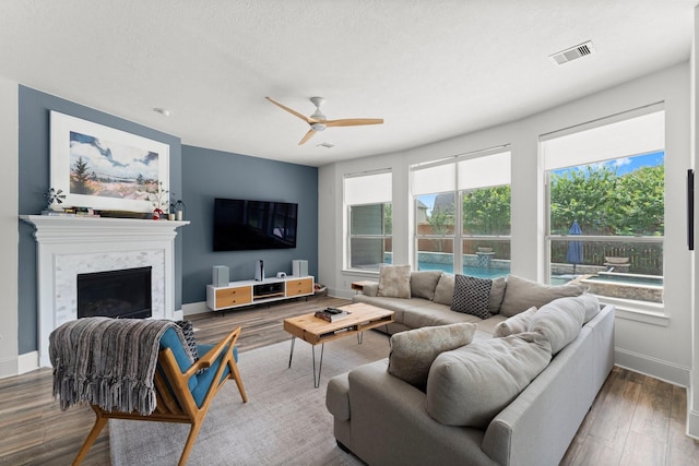 31013 Sunfall Trail Ln, Spring, TX 77386 - living room featuring ceiling fan, wood finished floors, and a fireplace