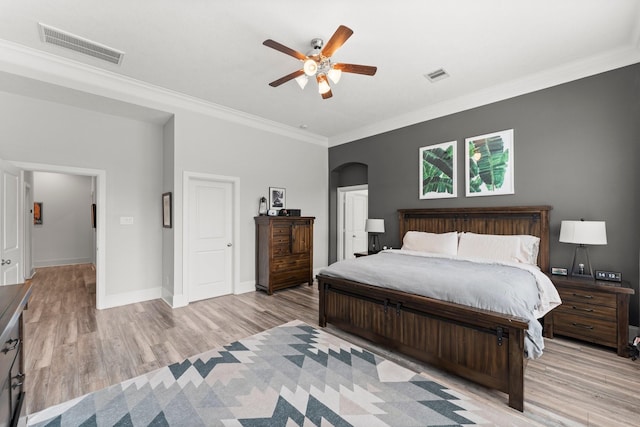31013 Sunfall Trail Ln, Spring, TX 77386 - bedroom featuring light wood-style flooring, ornamental molding, arched walkways, and a ceiling fan