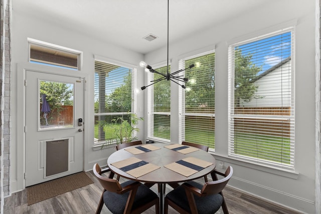 31013 Sunfall Trail Ln, Spring, TX 77386 - dining space with healthy amount of natural light, wood finished floors, and a chandelier