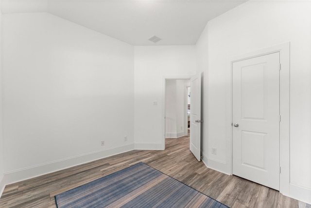 31013 Sunfall Trail Ln, Spring, TX 77386 - unfurnished bedroom featuring wood finished floors and lofted ceiling