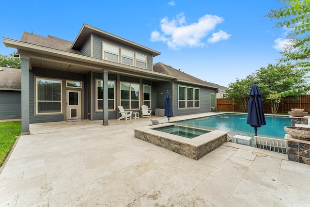 31013 Sunfall Trail Ln, Spring, TX 77386 - rear view of house featuring a patio, a fenced backyard, and a pool with connected hot tub