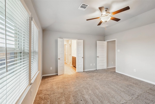 17533 Rosette Grass Dr, Conroe, TX 77385 - unfurnished bedroom featuring light colored carpet, lofted ceiling, ensuite bath, and ceiling fan