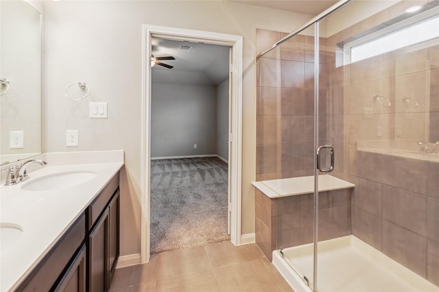 17533 Rosette Grass Dr, Conroe, TX 77385 - bathroom with double vanity, a ceiling fan, a stall shower, and tile patterned floors