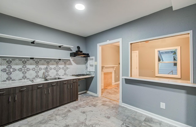523 N Jenkins St, Houston, TX 77003 - kitchen featuring open shelves, decorative backsplash, dark brown cabinetry, range hood, and stainless steel gas cooktop