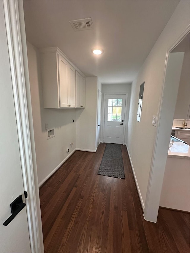 8018 Twining Oaks Ln, Spring, TX 77379 - laundry area featuring cabinet space, washer hookup, dark wood finished floors, electric dryer hookup, and gas dryer hookup