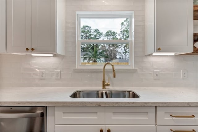8018 Twining Oaks Ln, Spring, TX 77379 - kitchen featuring stainless steel dishwasher, white cabinetry, and tasteful backsplash