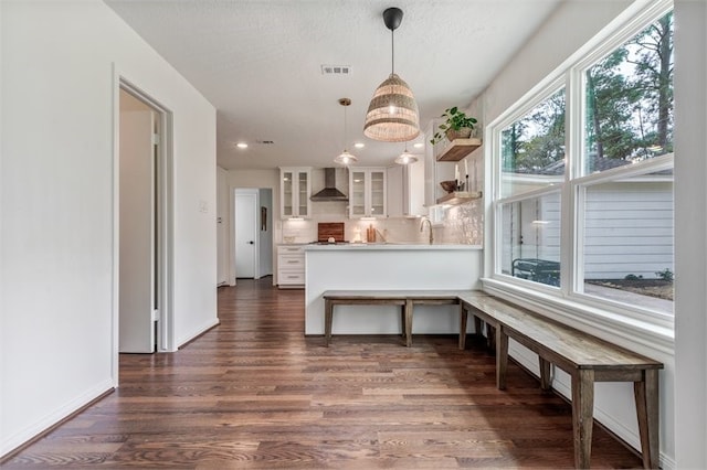 8018 Twining Oaks Ln, Spring, TX 77379 - kitchen with wall chimney range hood, white cabinets, dark wood-style floors, glass insert cabinets, and open shelves