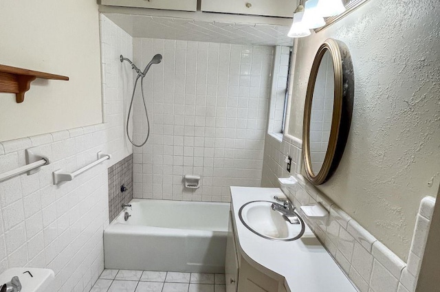 1092 S Holland St, Bellville, TX 77418 - full bath with tile walls, vanity, tile patterned floors, shower / bath combination, and wainscoting