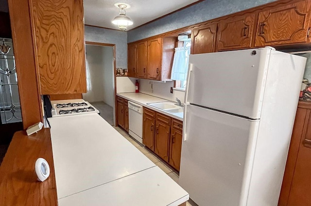 1092 S Holland St, Bellville, TX 77418 - kitchen with white appliances, brown cabinets, and light countertops