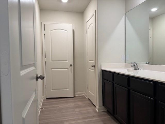 1017 Misty Patch Dr, Katy, TX 77493 - bathroom with vanity, wood finished floors, and recessed lighting