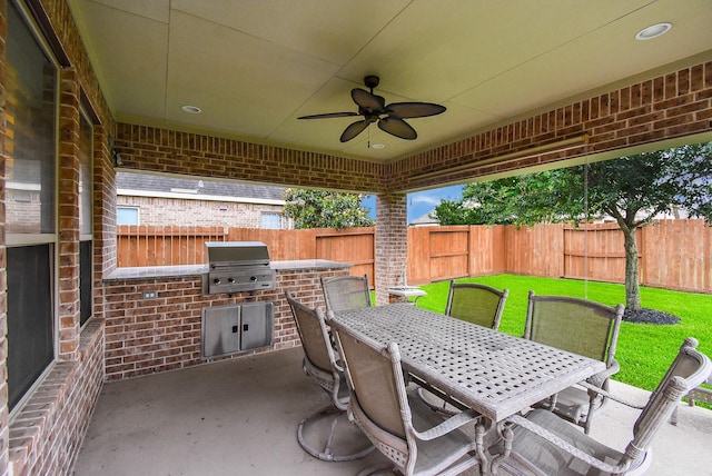 19510 Cisco Ct, Cypress, TX 77433 - fenced backyard featuring an outdoor kitchen, outdoor dining area, a ceiling fan, and a patio