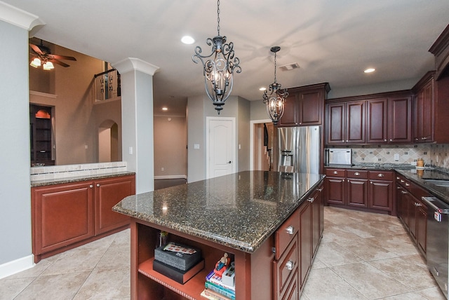 19510 Cisco Ct, Cypress, TX 77433 - kitchen featuring appliances with stainless steel finishes, decorative backsplash, a chandelier, light tile patterned flooring, and recessed lighting