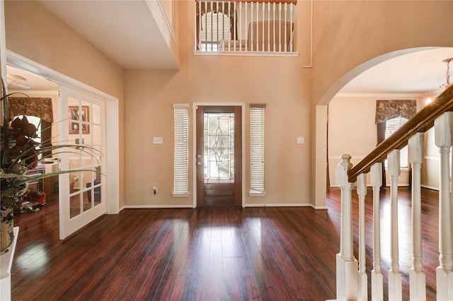 18719 Glenn Haven Estates Dr, Spring, TX 77379 - entrance foyer with healthy amount of natural light, arched walkways, wood-type flooring, and a high ceiling