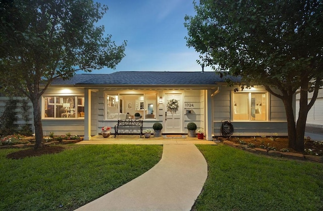 1726 Saxon Dr, Houston, TX 77018 - rear view of house featuring covered porch, a lawn, and a shingled roof