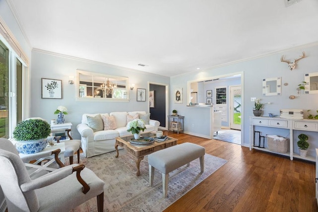 1726 Saxon Dr, Houston, TX 77018 - living room featuring ornamental molding, wood finished floors, and a chandelier