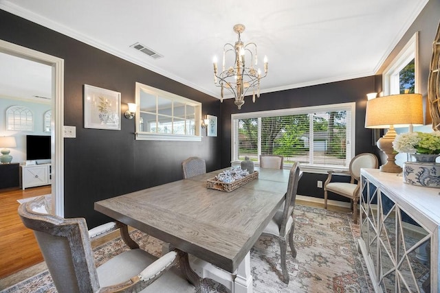 1726 Saxon Dr, Houston, TX 77018 - dining room with a chandelier, wood finished floors, and crown molding