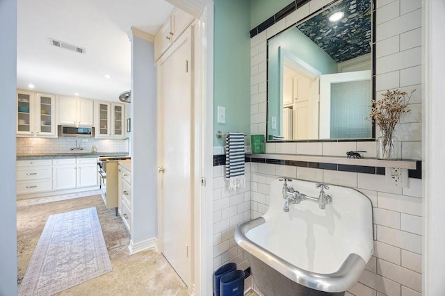 1726 Saxon Dr, Houston, TX 77018 - full bath with decorative backsplash, tile walls, a freestanding bath, vanity, and recessed lighting