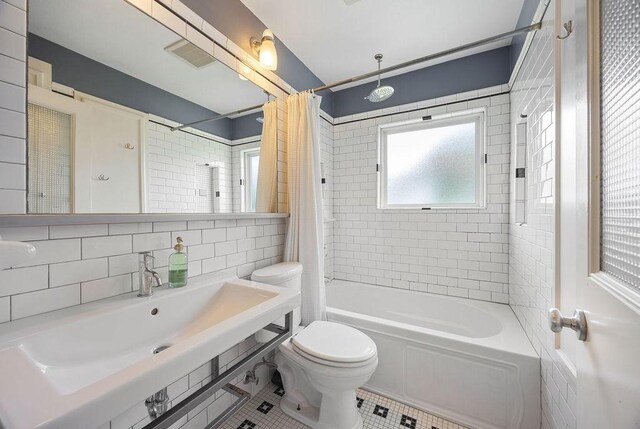 1726 Saxon Dr, Houston, TX 77018 - full bath with shower / bath combo, tile patterned floors, tile walls, and tasteful backsplash