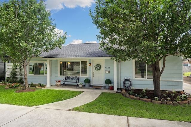 1726 Saxon Dr, Houston, TX 77018 - ranch-style house with roof with shingles, a front yard, and covered porch