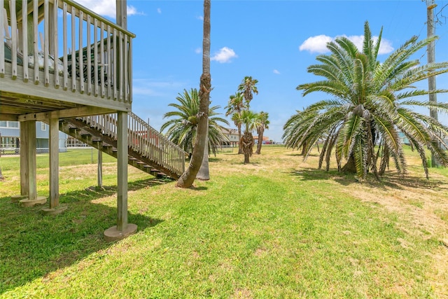 314 Oyster St, Surfside Beach, TX 77541 - view of grassy yard featuring stairs and a wooden deck
