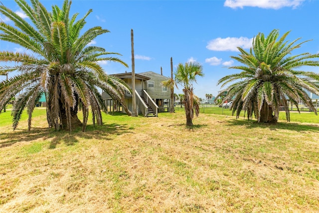 314 Oyster St, Surfside Beach, TX 77541 - view of grassy yard with stairs