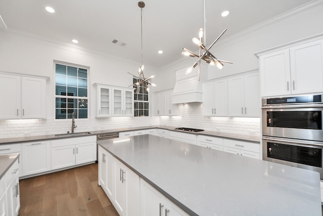 861 Dunleigh Meadows Ln, Houston, TX 77055 - kitchen featuring appliances with stainless steel finishes, a chandelier, crown molding, backsplash, and white cabinets