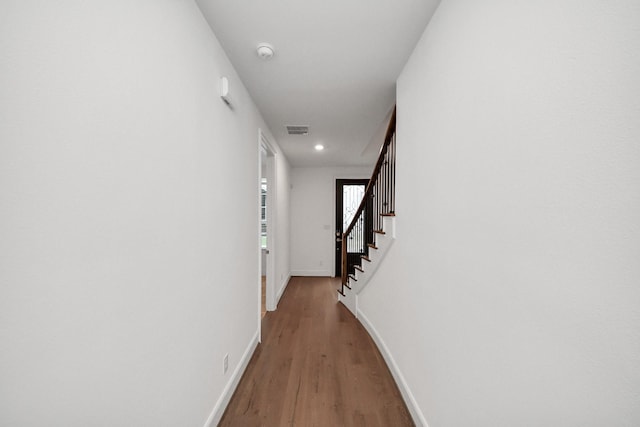 861 Dunleigh Meadows Ln, Houston, TX 77055 - hallway with wood finished floors, stairs, and recessed lighting