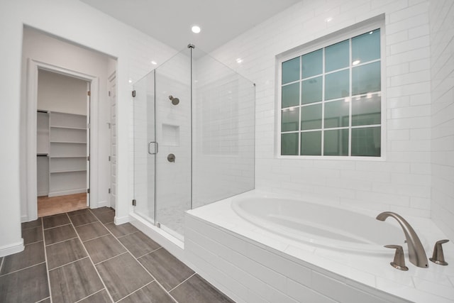 861 Dunleigh Meadows Ln, Houston, TX 77055 - full bathroom featuring a bath, a stall shower, and a spacious closet