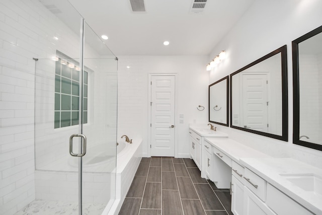 861 Dunleigh Meadows Ln, Houston, TX 77055 - full bath with double vanity, a bath, a stall shower, and recessed lighting